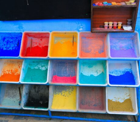 Array of colorful powdered pigments in plastic trays, perfect for art projects or decoration.